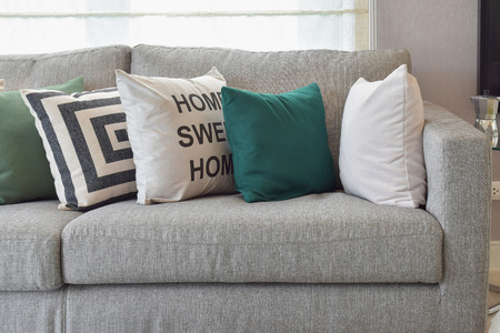 42537488 - retro pillows on the cozy grey sofa in the living room